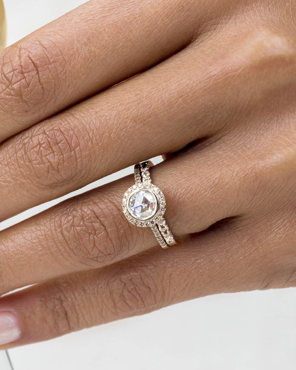 Soma Rose Cut Diamond with Champagne Halo Ring and Eternity Champagne Diamond Band on figure