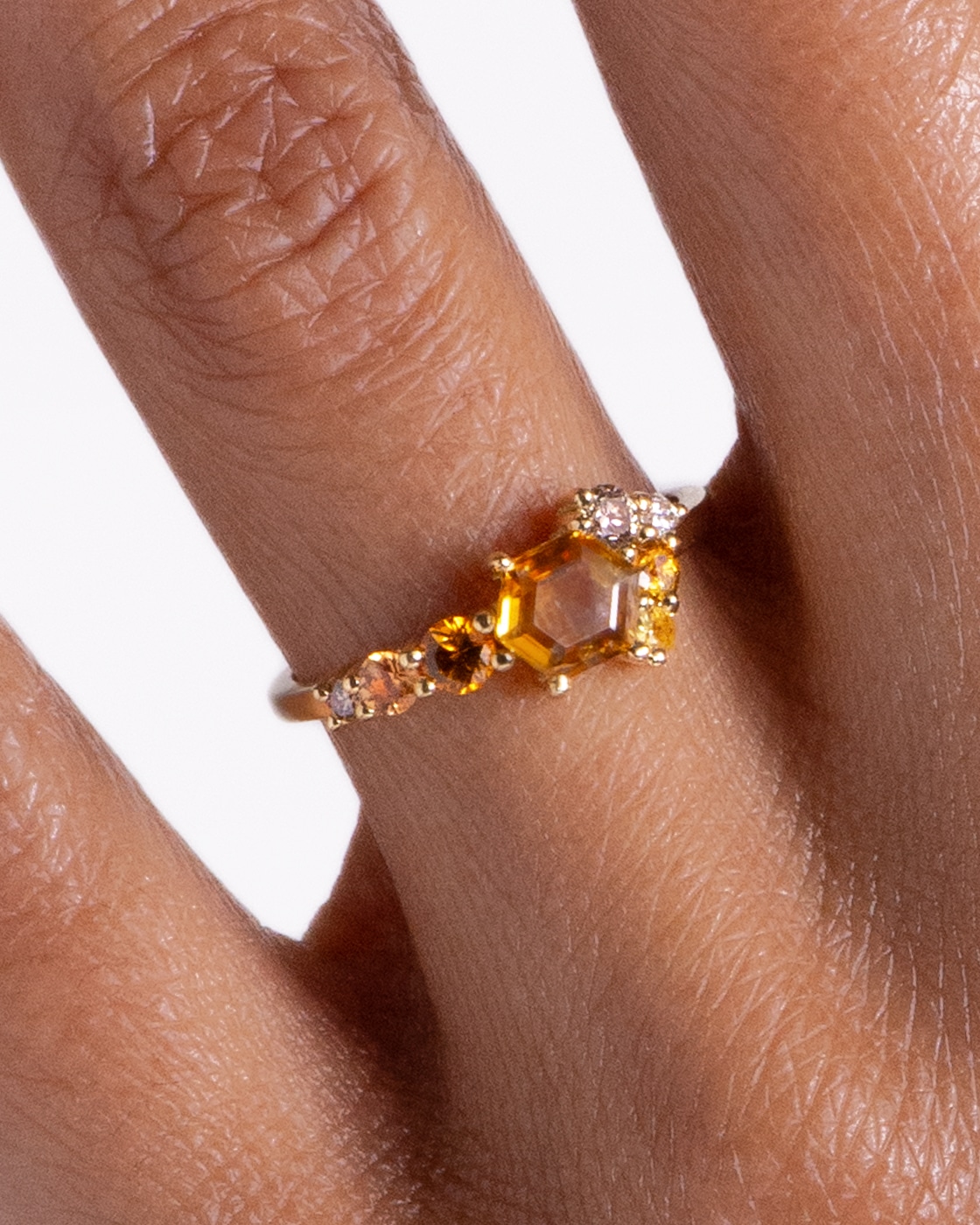 Radial Cluster Hex Apricot Sapphire Ring on figure