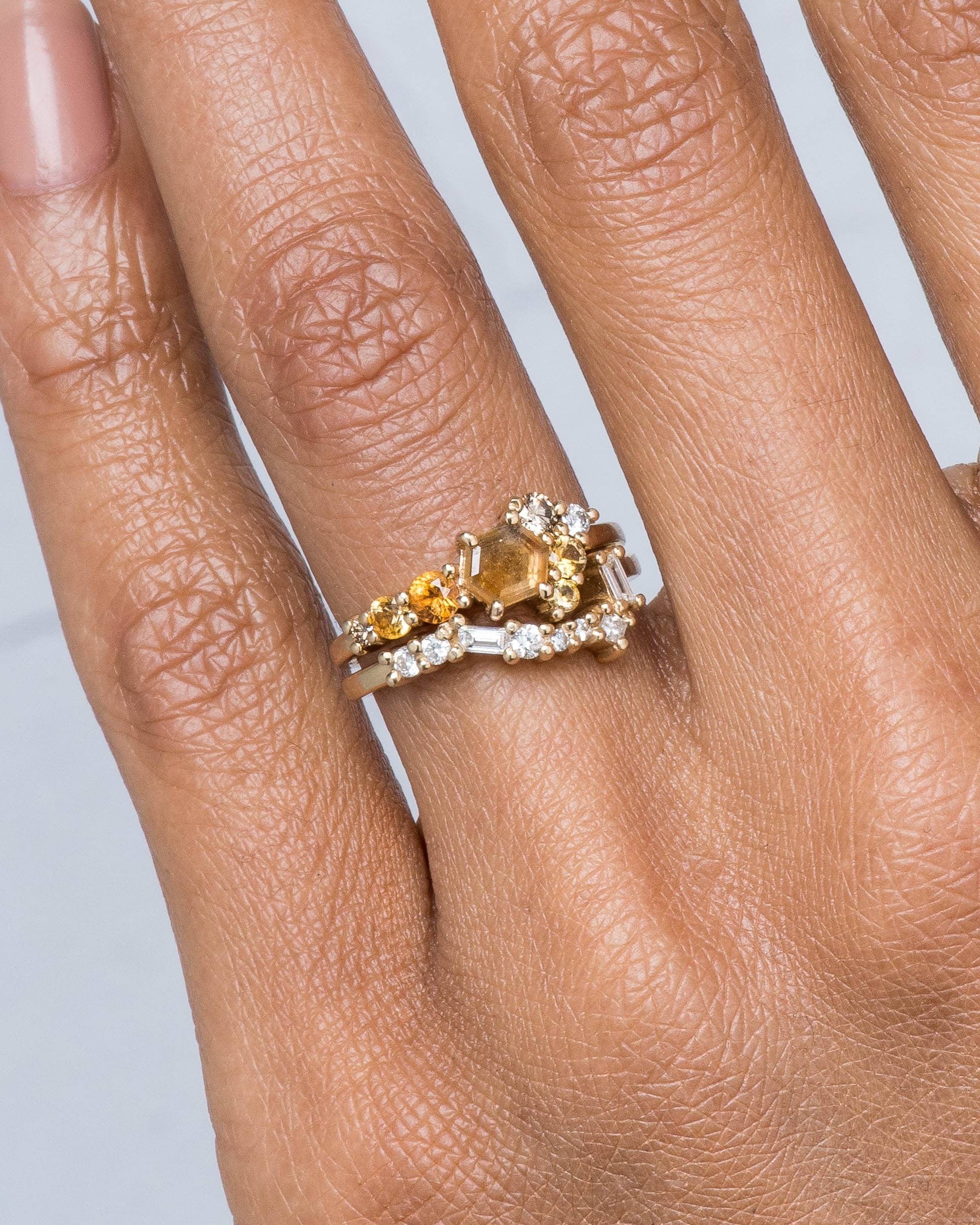 Radial Cluster Hex Apricot Sapphire Ring and Burst Cluster Diamond Band on figure