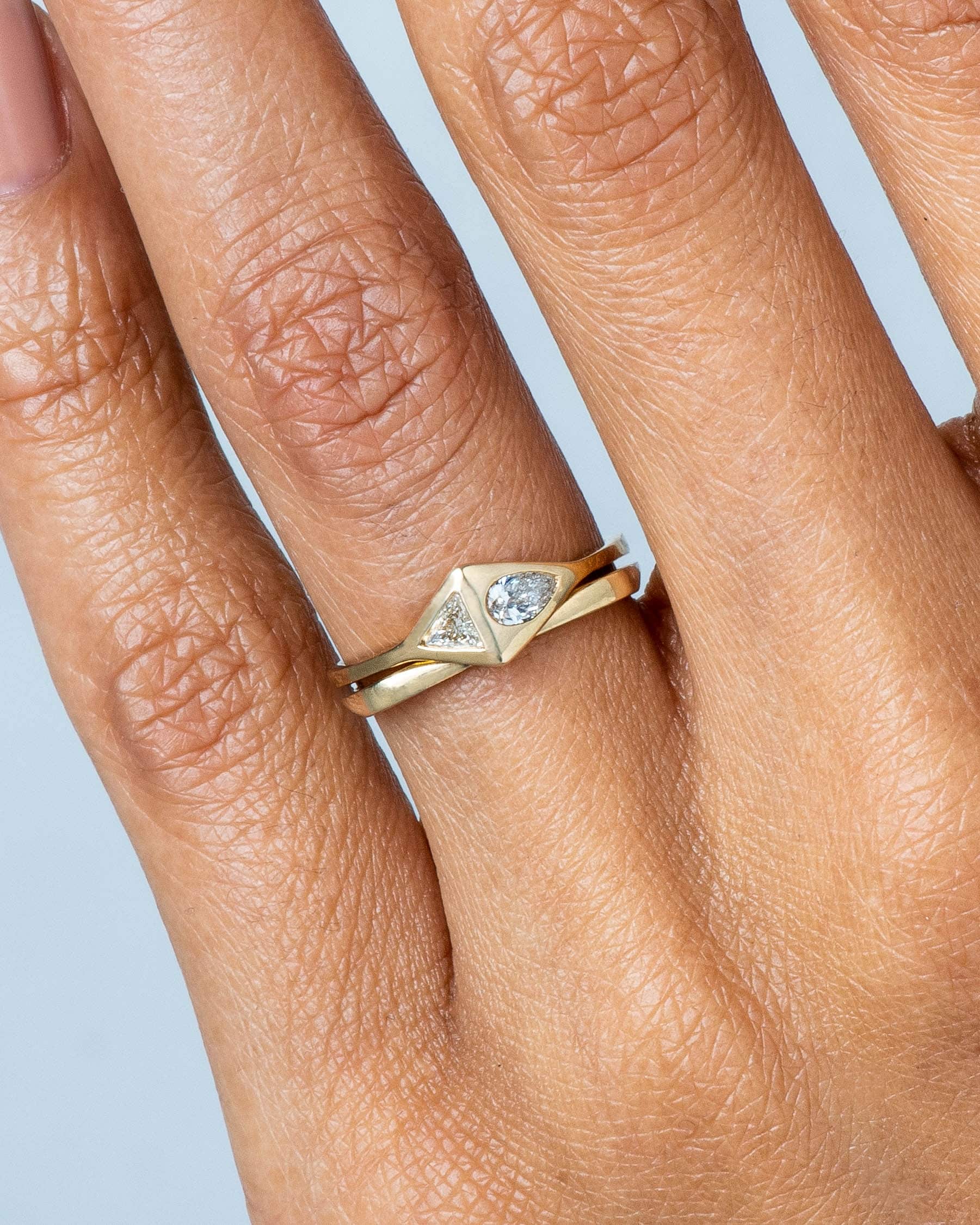 Icon Narrow Band and Pear Trillion Ring on figure
