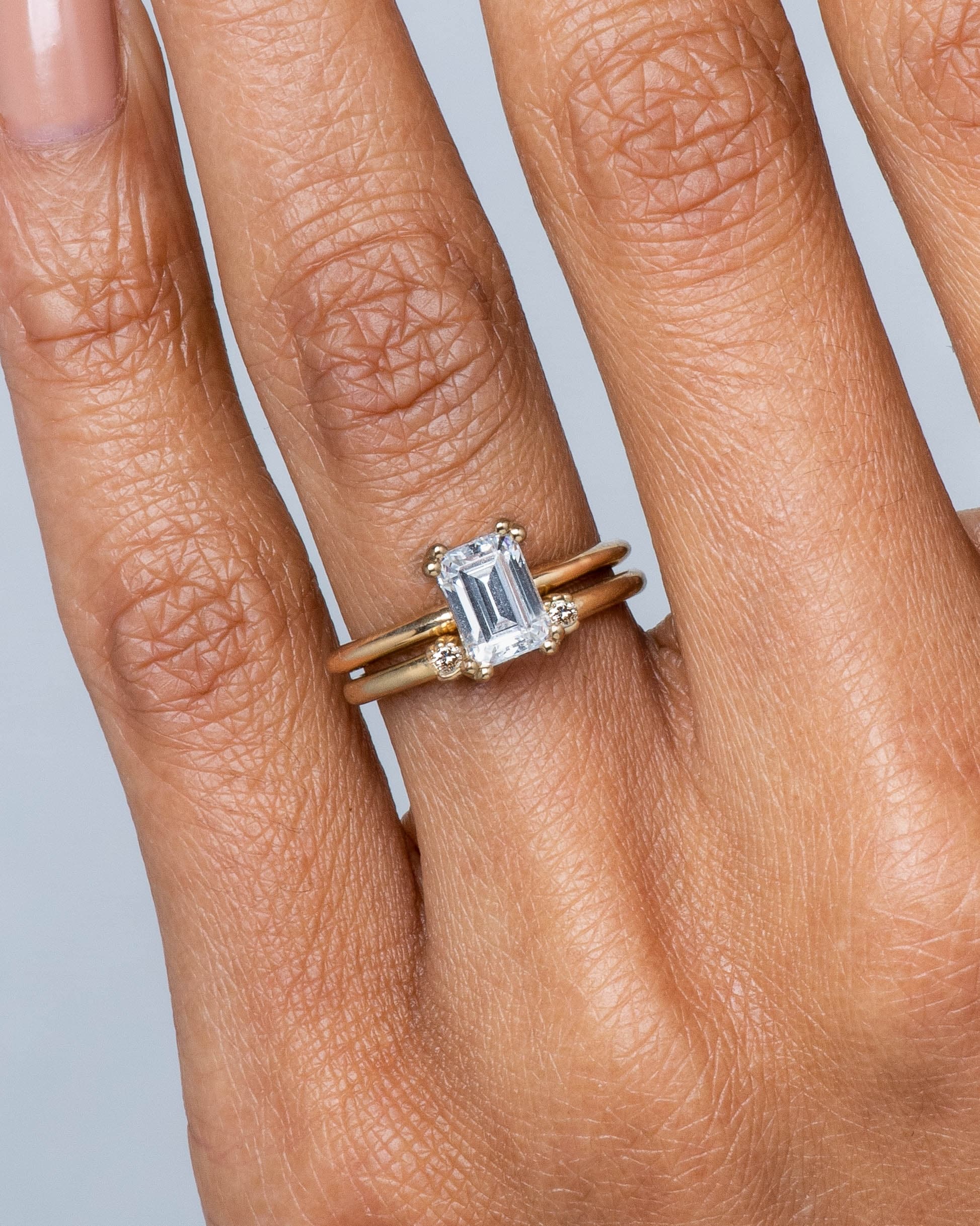 Ray Diamond Emerald Cut Ring and Open Lash Mini Champagne Diamond Ring on figure