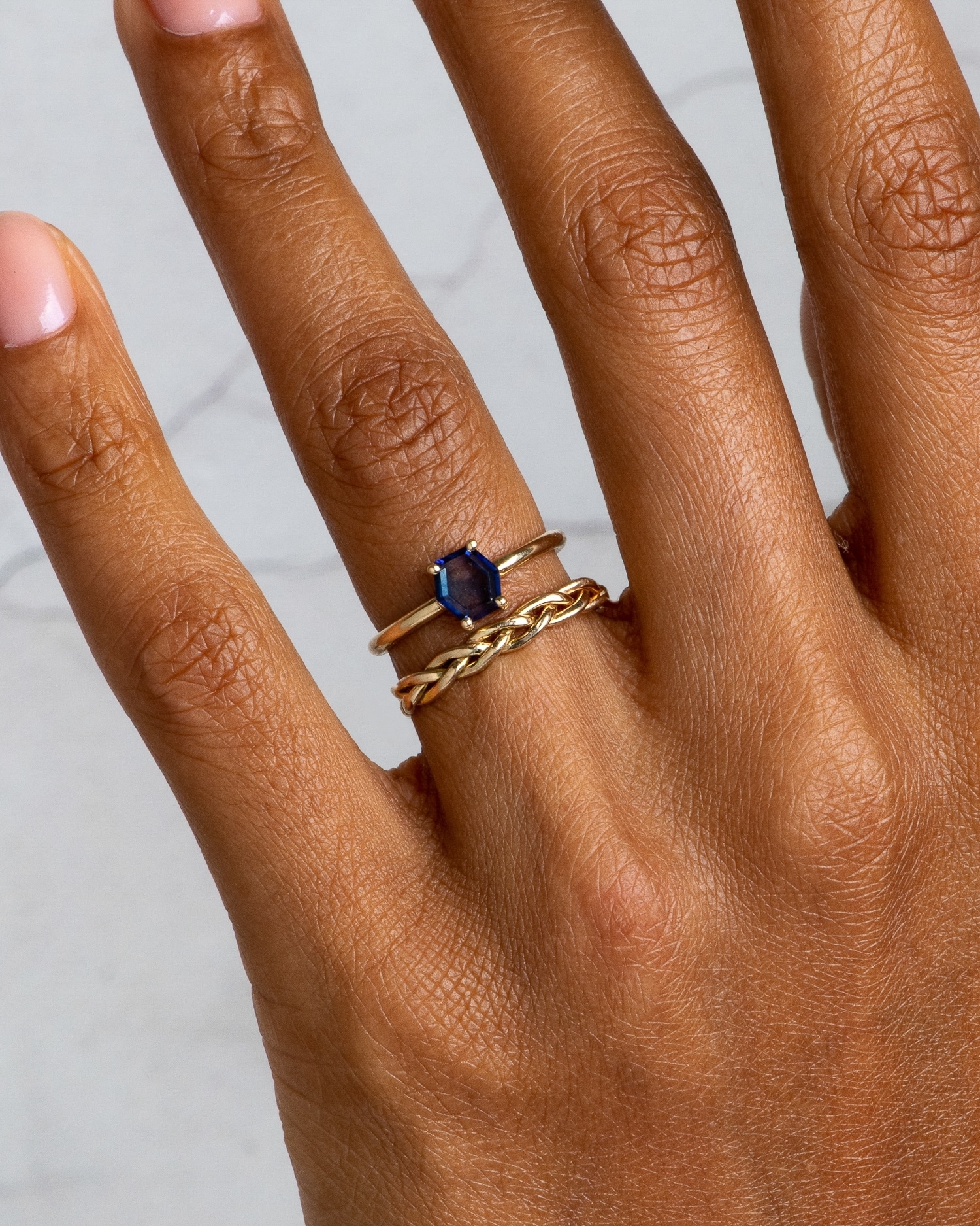 Kalmia Hex Blue Sapphire Ring and Aldine Band on figure