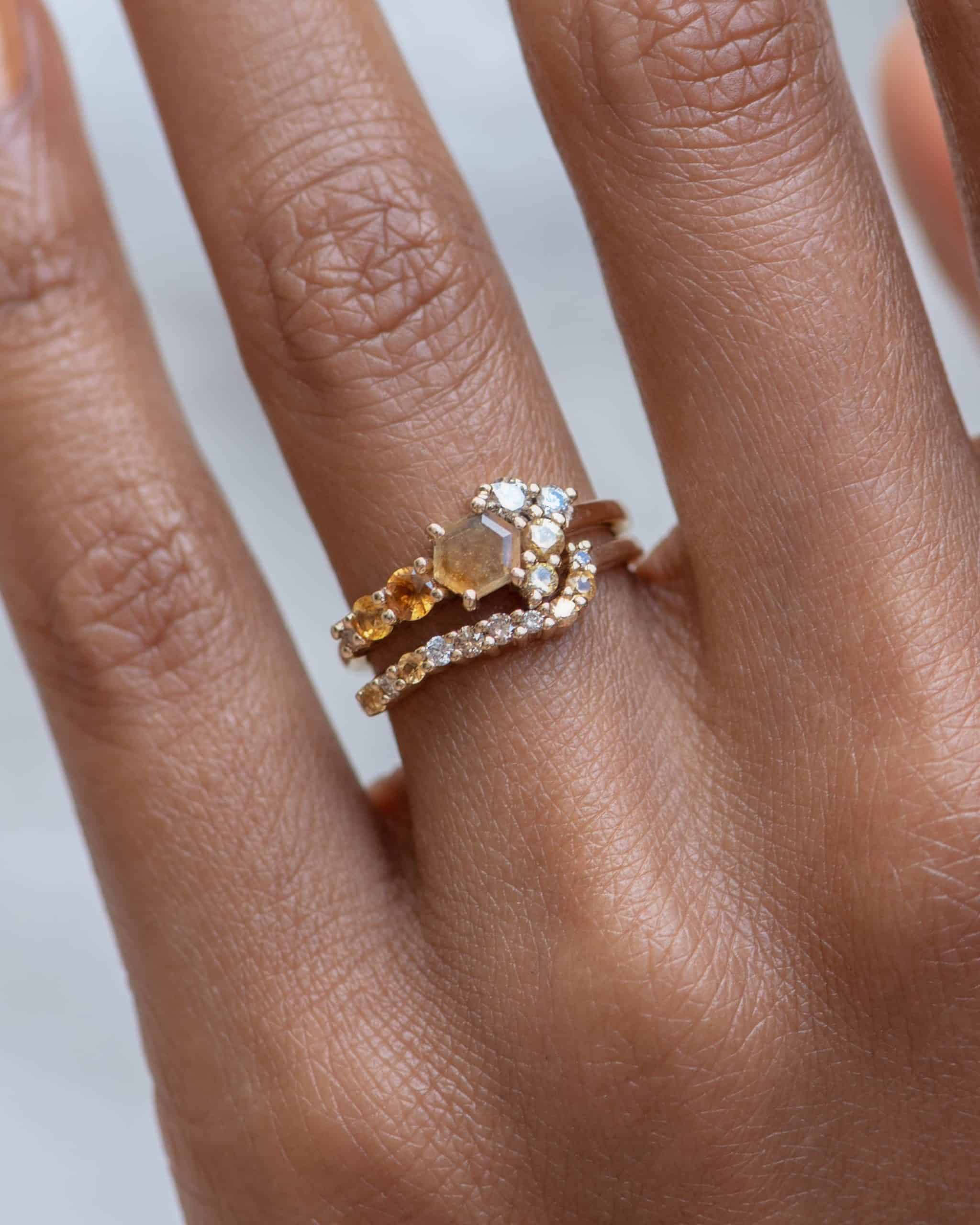 Radial Cluster Diamond with Yellow Sapphire Band and Radial Cluster Hex Apricot Sapphire Ring on figure