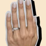 Collage image of a hand wearing a Bario Neal recycled palladium wedding band with a drop shadow.