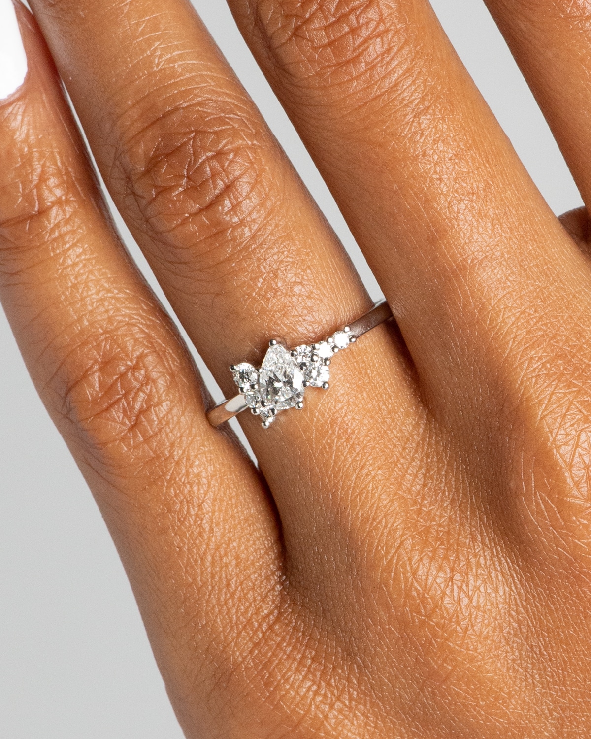 CUST_Burst_Cluster_Pear_Diamond_Ring_PLAT_Simmons_on_Figure_WEB2