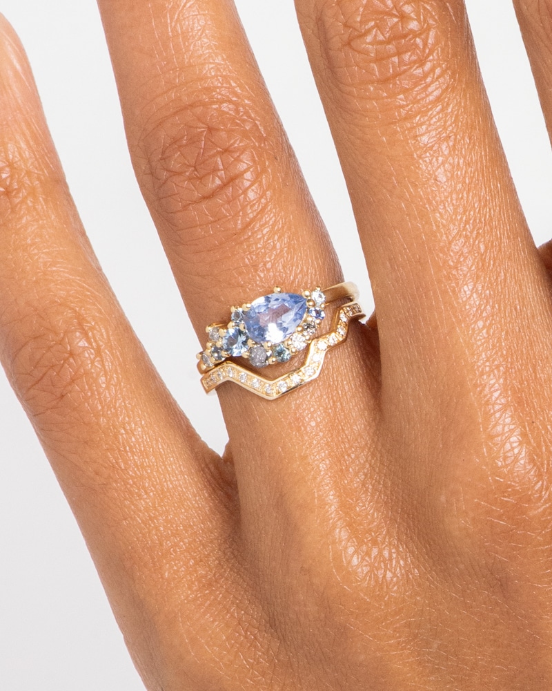 Sway Cluster Sky Blue Sapphire Ring with Linea Diamond Band on figure