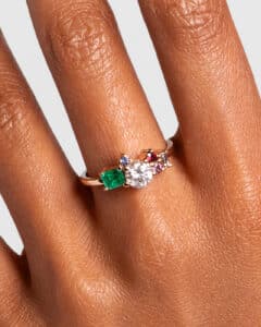 Custom Diamond, Emerald, and Sapphire Cluster Ring on figure