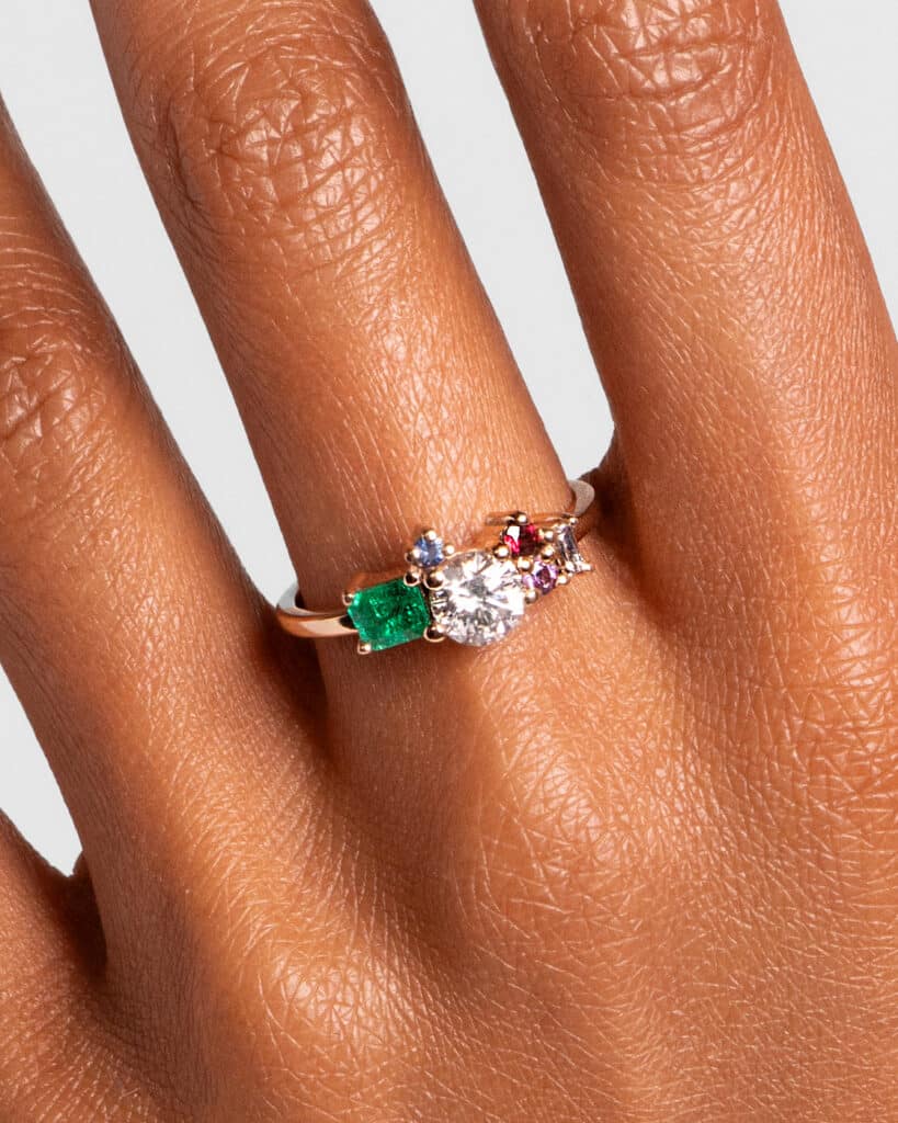 Custom Diamond, Emerald, and Sapphire Cluster Ring on figure