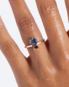 Custom Blue Green Sapphire and Dark Peach Zircon Ring on figure
