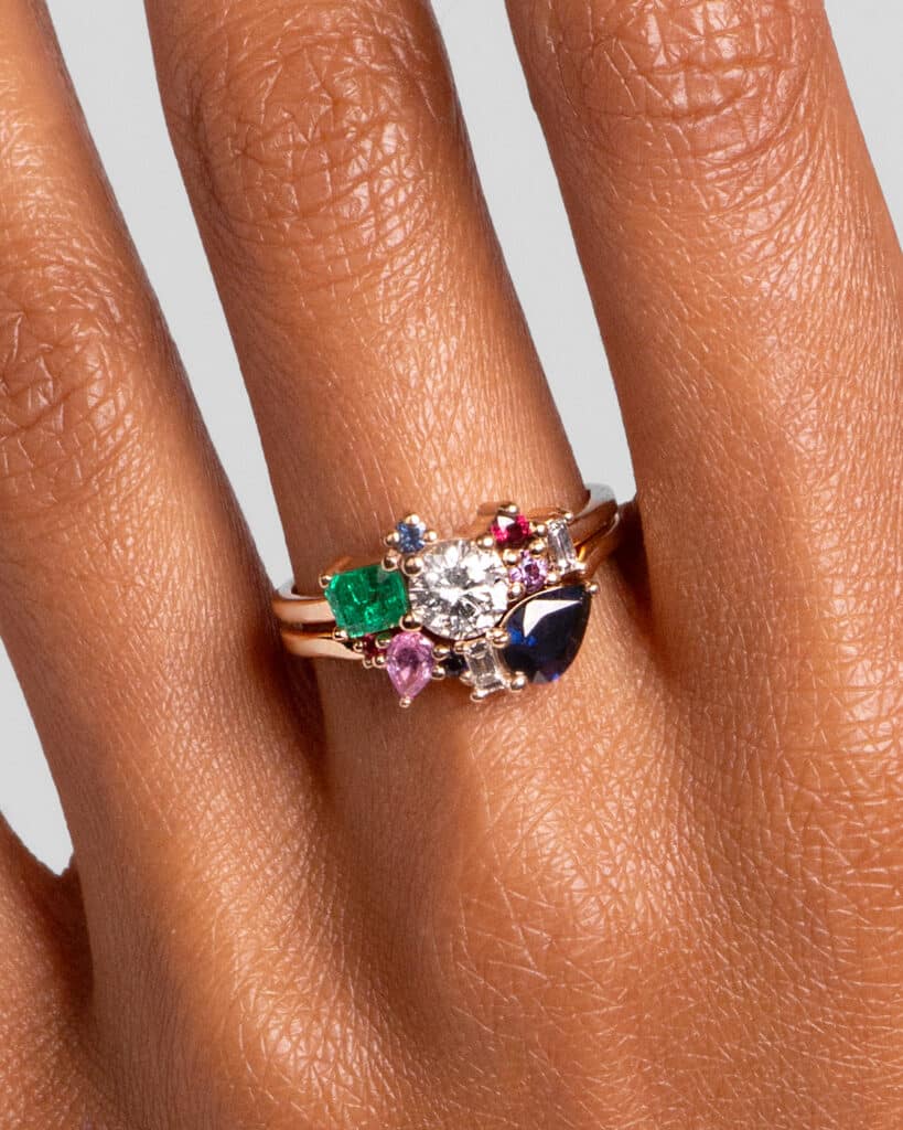 Custom Diamond, Emerald, and Sapphire Cluster Ring and Custom Blue and Pink Sapphire Jacket Band on figure