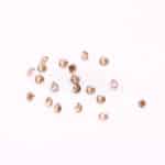 multiple loose round brown gemstones
